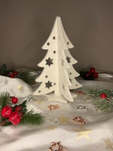 Λευκό πορσελάνινο τρισδιάστατο χριστουγεννιάτικο δέντρο με κοψίματα σε σχήμα αστεριών.